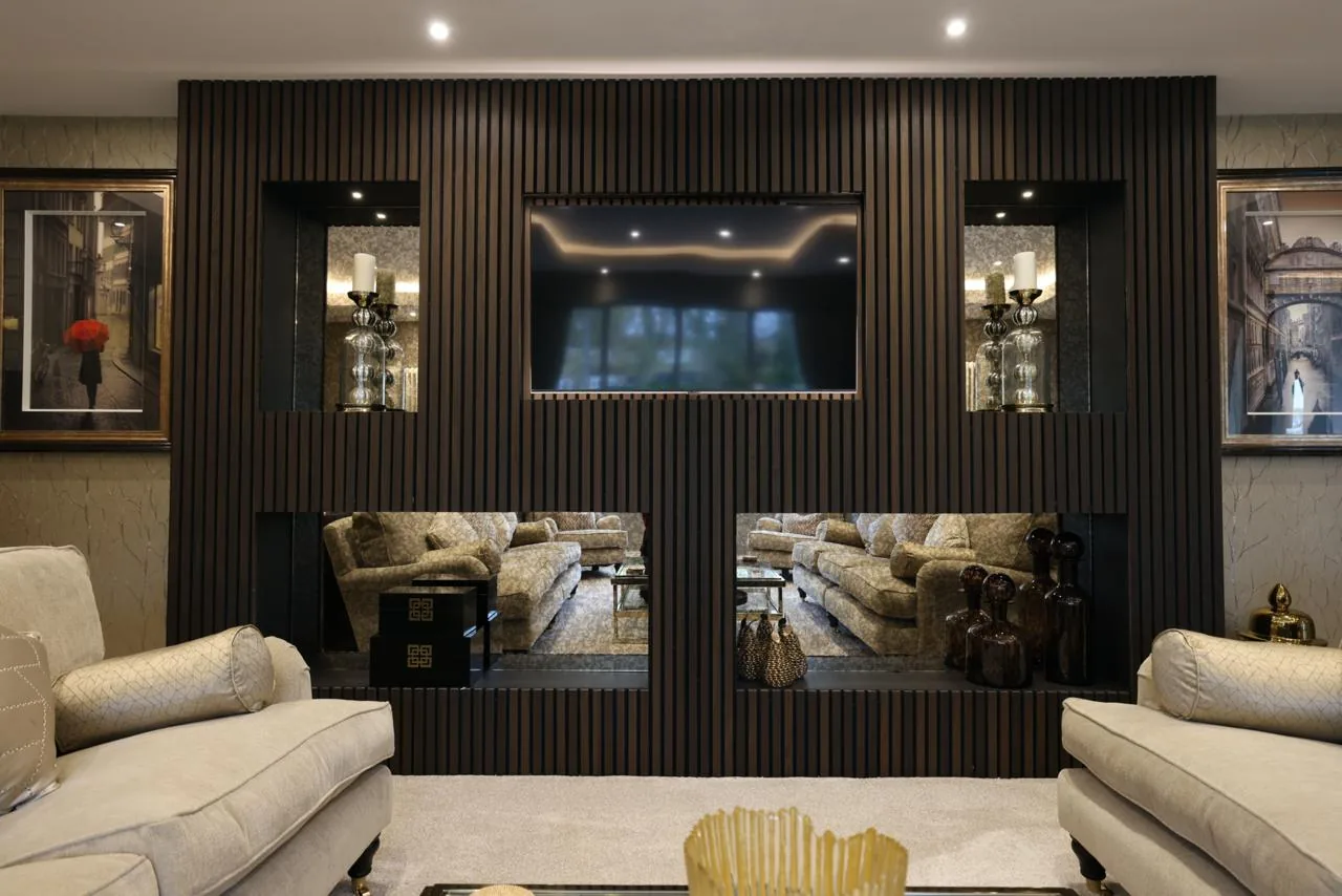 Living room with a dark slatted media wall and fireplace niches