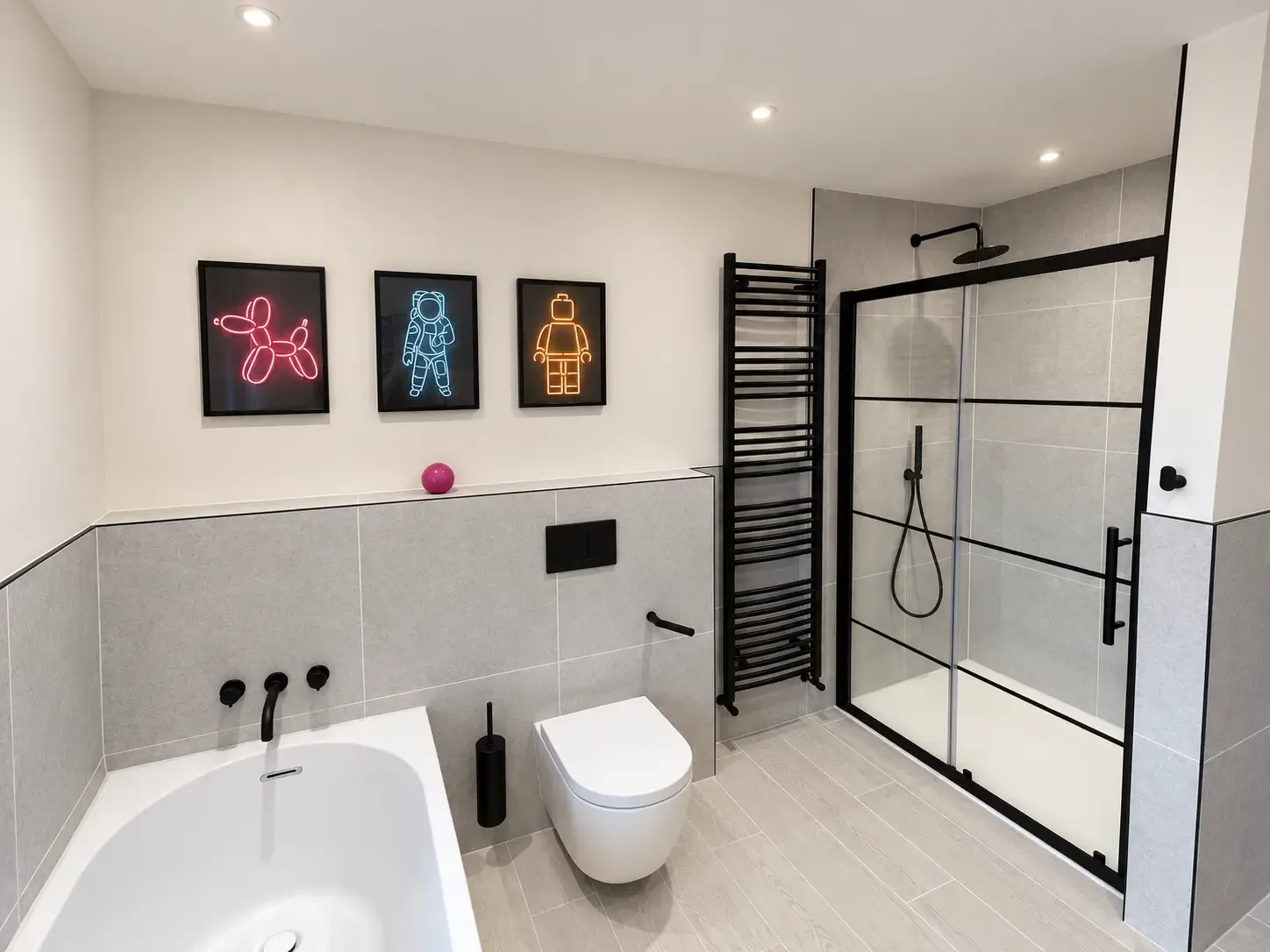 Bathroom with grey tiling, a bath and wall-hung WC with black fittings, a black towel radiator and a black-framed sliding shower enclosure